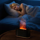 SnugGlow flame diffuser glowing on a nightstand while a woman sleeps